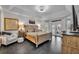 A bright bedroom features neutral decor, tiled floors, double doors to the outside and a tray ceiling at 5406 Baytowne Place, Oviedo, FL 32765