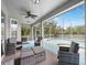Cozy screened-in patio with comfortable seating, offering a serene view of the pool and backyard at 5406 Baytowne Place, Oviedo, FL 32765