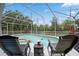 Screened-in pool area features a relaxing hot tub, lounge chairs, fountain and outdoor living at 5406 Baytowne Place, Oviedo, FL 32765