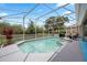 Gorgeous pool featuring a spa and lush landscaping within a screened enclosure for year-round enjoyment at 5406 Baytowne Place, Oviedo, FL 32765