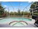 Inviting screened-in pool with integrated spa, fountain, and lush backyard surroundings for relaxation at 5406 Baytowne Place, Oviedo, FL 32765