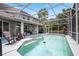 Beautiful screened-in pool with attached spa, fountain feature, and spacious patio for entertaining at 5406 Baytowne Place, Oviedo, FL 32765