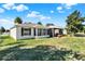 Charming home featuring a screened lanai and large lawn with a partial view of neighboring homes at 2337 St George Ave, The Villages, FL 32162