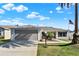 Charming single-story home showcasing well-maintained lawn, two-car garage, and inviting landscaping at 2337 St George Ave, The Villages, FL 32162