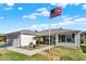 Inviting single-story home with well-kept lawn, stone walkway, and American flag at 2337 St George Ave, The Villages, FL 32162