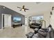 Open-concept living room featuring a ceiling fan, tile floors, and plenty of natural light at 2337 St George Ave, The Villages, FL 32162