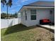 Backyard with grass and a white privacy fence featuring outdoor seating and a view of the house at 858 Lafayette Ln, Lakeland, FL 33805