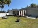 Expansive backyard featuring a cozy lounge area, well-manicured lawn, and perimeter fence at 858 Lafayette Ln, Lakeland, FL 33805