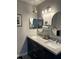 Bathroom featuring double vanity and modern fixtures with hanging decorative jar at 858 Lafayette Ln, Lakeland, FL 33805