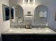 Elegant bathroom features double sinks, marble countertop, and silver framed mirrors at 858 Lafayette Ln, Lakeland, FL 33805