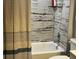 Bathroom with shower/tub combo and stylish rustic paneling at 858 Lafayette Ln, Lakeland, FL 33805