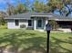 Charming home with a well-manicured lawn and beautiful landscaping at 858 Lafayette Ln, Lakeland, FL 33805