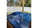 Outdoor hot tub features built in steps and jets surrounded by a privacy fence at 858 Lafayette Ln, Lakeland, FL 33805