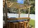 Outdoor wooden hot tub with a bar top and three wooden stools at 858 Lafayette Ln, Lakeland, FL 33805