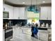 Modern kitchen featuring a marble island, stylish pendant lights, and stainless steel appliances at 858 Lafayette Ln, Lakeland, FL 33805