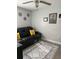 Cozy living room featuring a black leather sofa with a ceiling fan and decorative rug at 858 Lafayette Ln, Lakeland, FL 33805