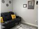 Living room featuring a comfortable black leather sofa with decorative pillows and a stylish area rug at 858 Lafayette Ln, Lakeland, FL 33805