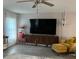 Relaxing living area with TV console and yellow accent chair at 858 Lafayette Ln, Lakeland, FL 33805