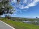 Scenic water view featuring a public walkway, lush grass, and a lily pad-filled lake at 858 Lafayette Ln, Lakeland, FL 33805