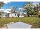 Large backyard with ample green space, featuring a sunny spot with a patio at 1729 Elk Dr, Lakeland, FL 33801