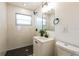 Bathroom featuring a modern vanity, black hardware, and a tiled walk-in shower at 1729 Elk Dr, Lakeland, FL 33801
