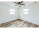 Bright bedroom featuring two windows, new flooring, and a modern ceiling fan at 1729 Elk Dr, Lakeland, FL 33801