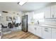 Kitchen with stainless steel appliances, white cabinets, and an adjacent dining area at 1729 Elk Dr, Lakeland, FL 33801