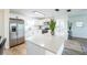 Well-equipped kitchen features stainless steel appliances, white cabinets, and a quartz island at 1729 Elk Dr, Lakeland, FL 33801