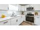 Well-lit kitchen showcasing white cabinets, stainless steel appliances, and modern countertops at 1729 Elk Dr, Lakeland, FL 33801