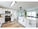 Bright, renovated kitchen featuring white cabinets, stainless steel appliances and an island with quartz countertops at 1729 Elk Dr, Lakeland, FL 33801