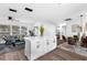 Open-concept living space with a kitchen island, dining area, and living room with large windows at 1729 Elk Dr, Lakeland, FL 33801