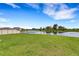 Beautiful backyard featuring a serene water view, complemented by lush greenery and a privacy fence at 4381 Pumice Dr, Lakeland, FL 33811