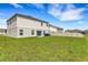 Spacious backyard features lush lawn, vinyl fence, and modern home exterior at 4381 Pumice Dr, Lakeland, FL 33811