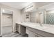 Bathroom featuring double sinks, a large mirror, and a shower with a geometric curtain at 4381 Pumice Dr, Lakeland, FL 33811