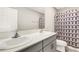 Bathroom featuring double sinks with gray cabinetry and modern geometric shower curtain at 4381 Pumice Dr, Lakeland, FL 33811