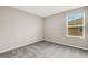 Bedroom with neutral walls, carpet flooring and a window letting in natural light at 4381 Pumice Dr, Lakeland, FL 33811