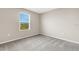 Bare carpeted bedroom features natural lighting, neutral walls, and outlets at 4381 Pumice Dr, Lakeland, FL 33811