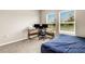 Bedroom featuring a wooden desk, chair, and two windows for natural light at 4381 Pumice Dr, Lakeland, FL 33811