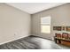 Empty bedroom with gray walls, laminate flooring, and a window that lets in natural light at 4381 Pumice Dr, Lakeland, FL 33811
