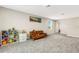 Spacious bonus room features plush gray carpeting and a brown leather futon at 4381 Pumice Dr, Lakeland, FL 33811