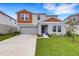 Charming two-story home featuring an attached two-car garage and manicured front lawn at 4381 Pumice Dr, Lakeland, FL 33811