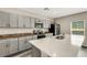 Modern kitchen featuring gray cabinets, stainless steel appliances, and a bright white countertop island at 4381 Pumice Dr, Lakeland, FL 33811