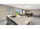 Bright kitchen with an island and stainless steel sink, overlooking a spacious backyard and living area at 4381 Pumice Dr, Lakeland, FL 33811