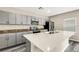 Modern kitchen featuring an island, stainless steel appliances, and sleek gray cabinets at 4381 Pumice Dr, Lakeland, FL 33811