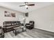 Cozy living room showcasing modern flooring, neutral walls, and comfortable leather seating at 4381 Pumice Dr, Lakeland, FL 33811