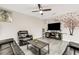 Comfortable living room featuring a ceiling fan, sleek gray flooring, and a wall decal at 4381 Pumice Dr, Lakeland, FL 33811