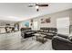 Open-concept living area featuring modern flooring, a ceiling fan, and a view of the dining and kitchen areas at 4381 Pumice Dr, Lakeland, FL 33811