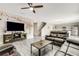 Open-concept living room featuring modern gray floors and decor flowing into the kitchen area at 4381 Pumice Dr, Lakeland, FL 33811