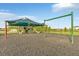 Community playground with swings, a slide, and climbing structures, all shaded for outdoor fun at 4381 Pumice Dr, Lakeland, FL 33811