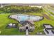 Aerial view of a community pool area with palm trees, ample seating, and a clubhouse at 4381 Pumice Dr, Lakeland, FL 33811